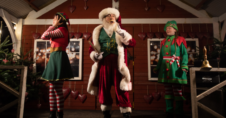 Santa and two elves performing at AGLOW event at Auckland Palace